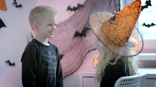 Halloween Kids Brother and Sister Preparing to Halloween Put on Costume at Home alt