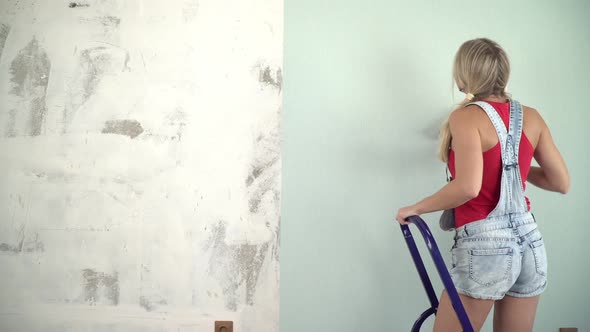 Attractive Sexy Woman Makes Home Repairs and Glues Wallpaper alt