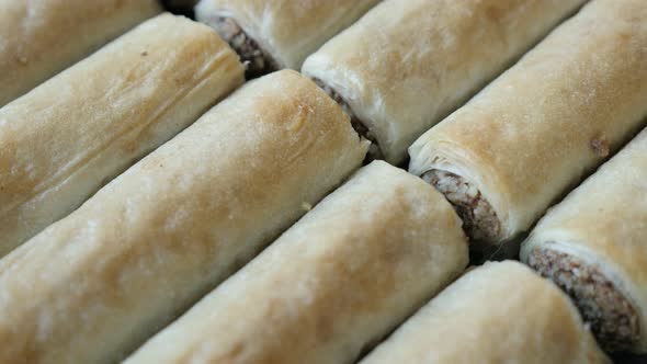 Tilting over filo dough sweet rolls 4K 2160p 30fps UHD footage - Traditional Turkish phyllo pie with alt