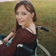 Beautiful Disabled Caucasian Woman Looking Over the Shoulder in the Park - VideoHive Item for Sale