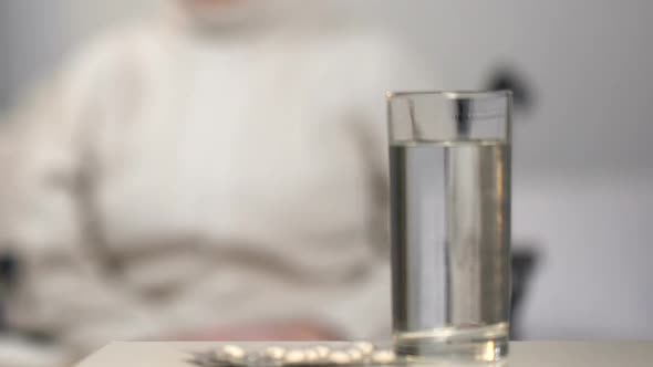 Elderly Lady in Wheelchair Feeling Depressed of Taking Pills Necessity, Despair alt