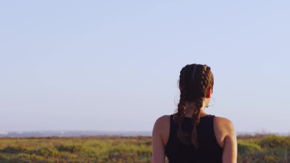 Hippie Woman with Braided Hair Walking in Nature at Sunset