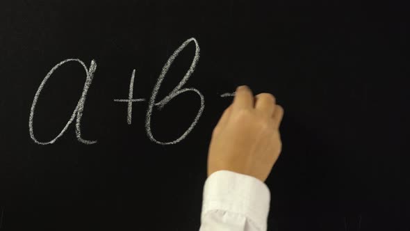 Hand Writing with Chalk on Chalkboard Mathematical Equation, a Plus b Equals c alt