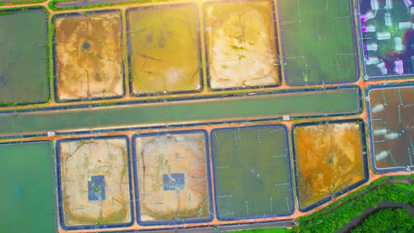 An aerial view over a drone flying over a large shrimp farm alt
