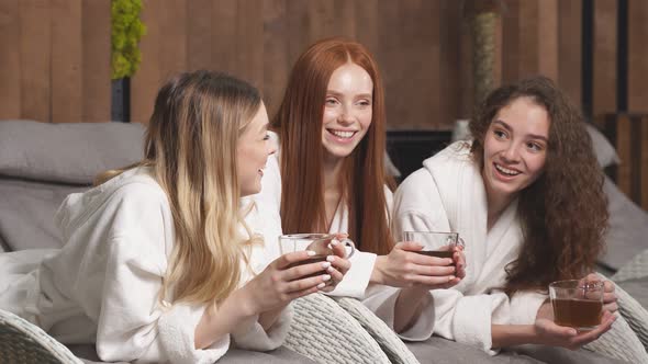 Attractive Ladies Drinking Herbal Tea Resting in Spa Salon Relaxing