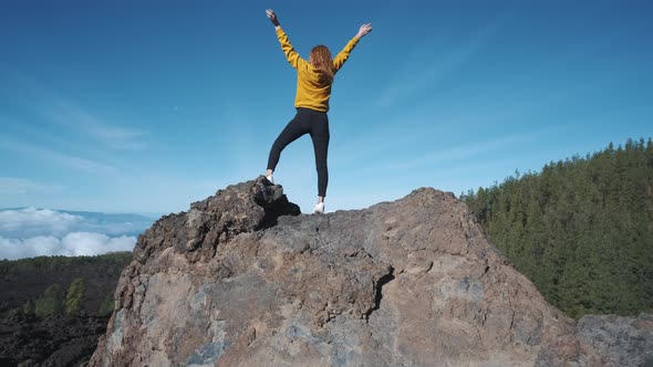 Young Woman Tourist Climbed to the Top of a Volcanic Stone alt