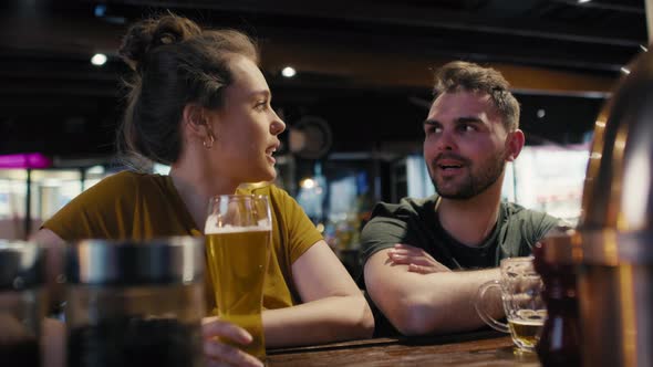 Caucasian man and woman talking together in the bar. Shot with RED helium camera in 8K.  alt