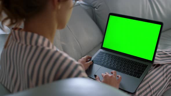 Woman Looking Green Screen Laptop at Remote Workplace Closeup alt
