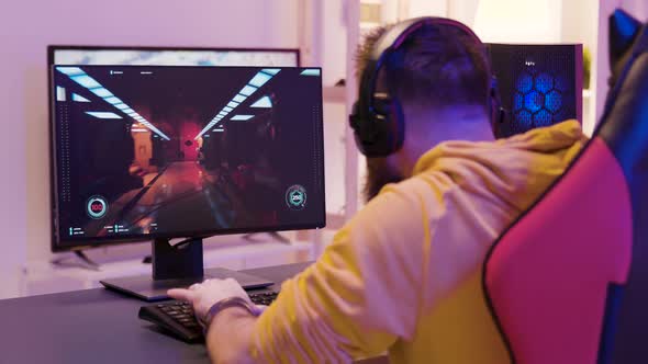 Over the Shoulder Footage of Man Playing Professional Video Games alt