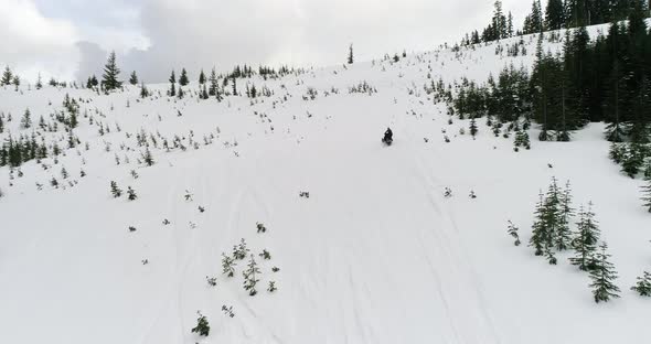 Person Riding Snowmobile Snowmachine Rally Fast Driving Uphill Steep Snow Slope alt