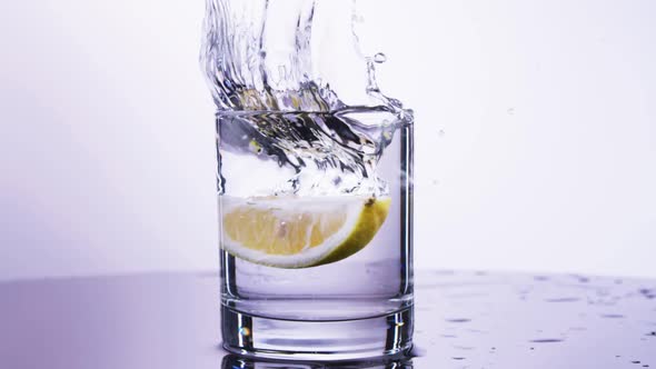 lemon drop in cup of water white background