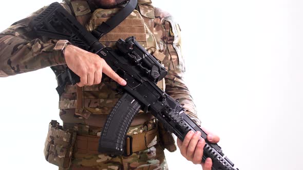 Special Forces scout wearing a multicam tactical outfit with a flak jacket and a combat rifle