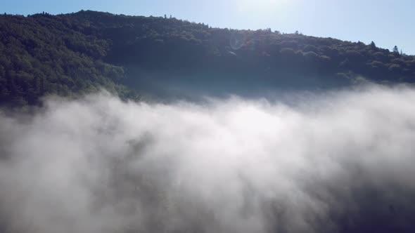 Flight Over the Cloud on Top of the Mountain. A Cloud Formed on Top of a Mountain. alt