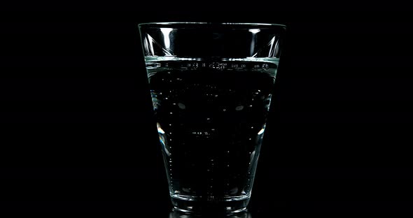 Sparkling Water in a Glass against Black Background, Real Time 4K
