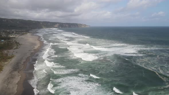 Sandy beach in sunny day in Yogyakarta, Indonesia, Parangtritis Beach. Dramatic light alt