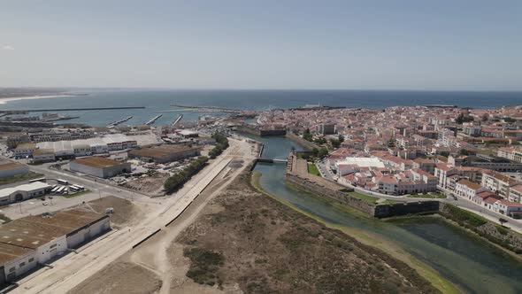 Peniche peninsula, Portugal. Sprawling cityscape, harbour and Atlantic ocean. Aerial view