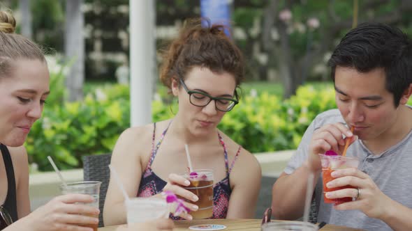 Group of friends in Hawaii toasting with cocktails