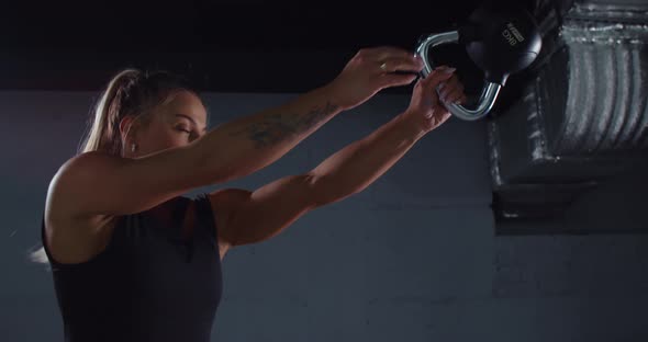 Muscular Woman Doing Exercises with Kettlebell alt