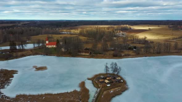 Araisi Lake Castle in Latvia Aerial Shot From Above. Historical Wooden Buildings on Small Island in alt