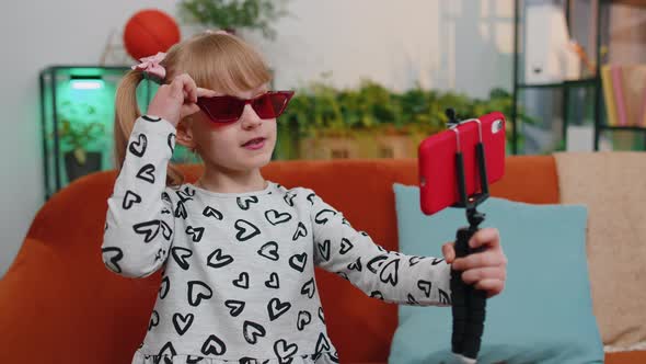 Girl Kid Enjoying Conversation on Mobile Phone with Friend Relaxing Sitting on Couch at Home Alone alt