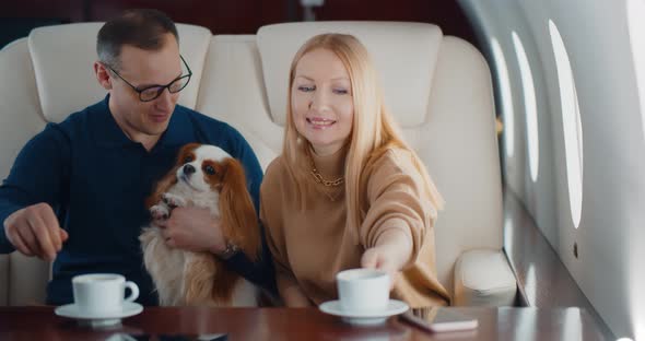 Air Hostess Serving Coffee for Mature Couple in First Class Cabin alt