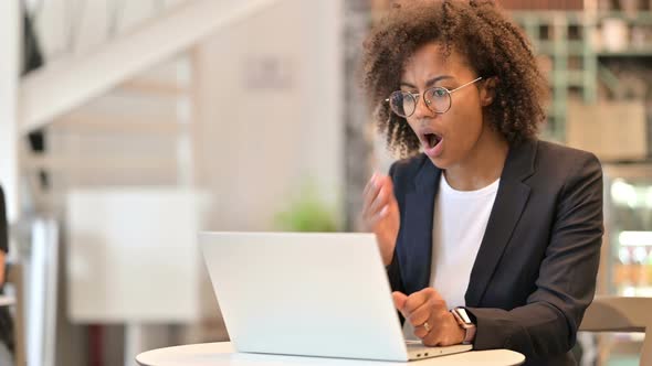 Loss, African Businesswoman Reacting To Failure on Laptop at Cafe  alt