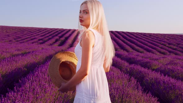 Portrait of a Blonde Woman with Hat in Lavender Fields on Summer