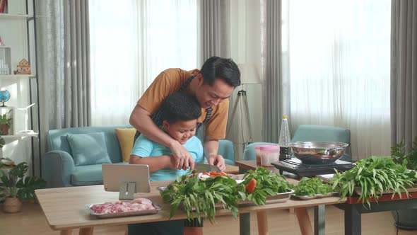 Asian Father Teach His Son How To Cook At Home alt