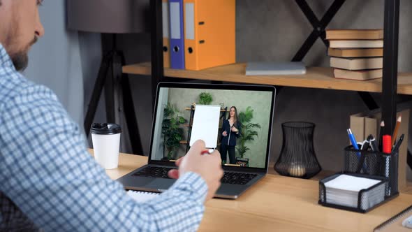 Businessman Writes in Notebook Studying Online Education Business Course Laptop alt