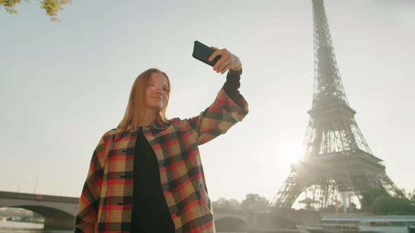 Young Lady Takes Selfie Picture By Smartphone with Eiffel Tower in Paris France