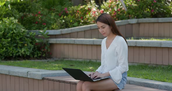 Woman work on laptop computer at outdoor