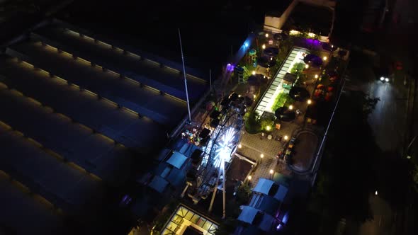 amusement park with a big chicago wheel, on the roof of a shopping center alt