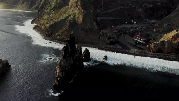 Drone circle orbit around sea stack near Ribeira Da Janela coast, Madeira Island Portugal