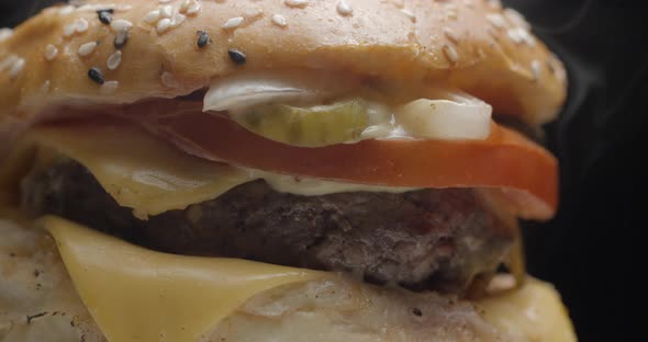 Burger close-up rotating in studio. Tasty fast food.