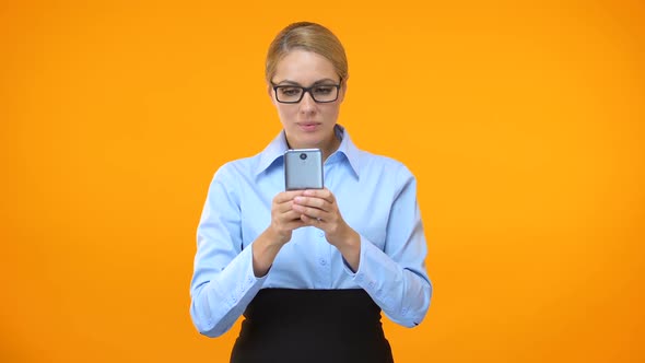 Young Cheerful Business Woman Reading Email on Smartphone, Successful Deal alt