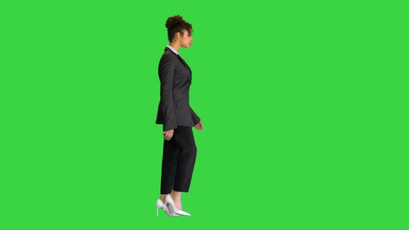 Young African American Businesswoman Walking on a Green Screen Chroma Key alt