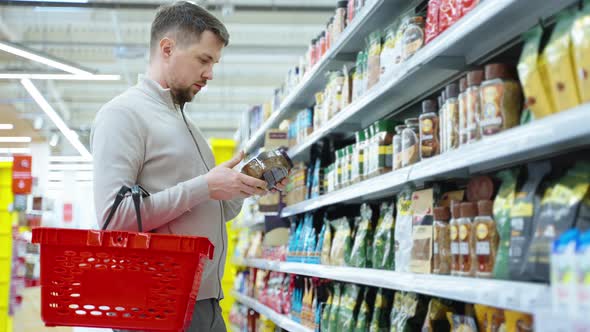Coffee Lover is Choosing Instant Coffee in Supermarket Man is Buying Soluble Coffee alt