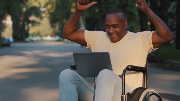 Mature Adult Paralyzed African American Man Using Laptop Received Good News Email Job Offer or alt