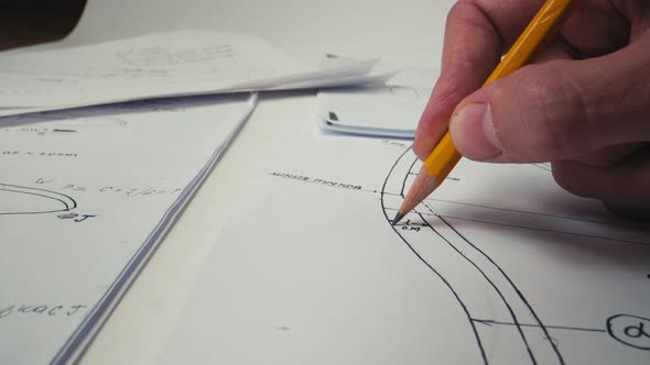 Close Up Man Hand's Drawing Sketch Pencil an Object To Be crafted.Business Charts and Graphs Drawing alt