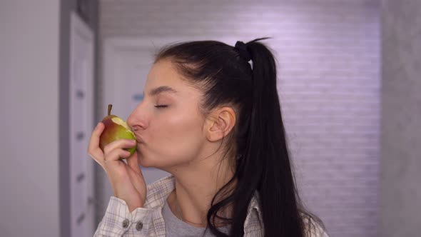 Attractive Woman Biting Juicy Pear Close Up