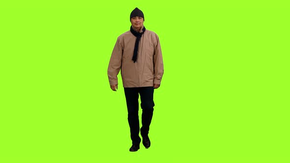Man in Brown Jacket Walks on Green Background alt