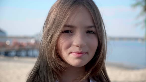 Close Up Portrait Individual Little Girl Looking Serious Contemplative Kid Standing on a Sunny Beach alt