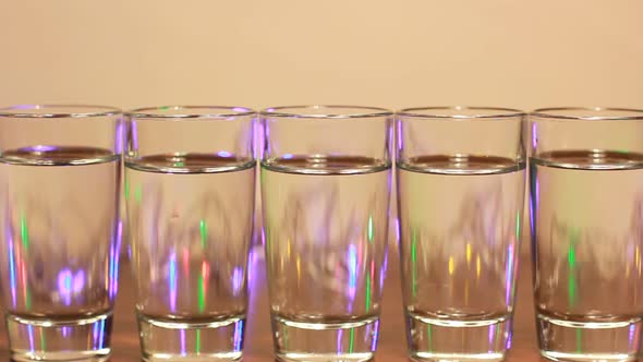 Acohol Glasses With Party Lamps Background