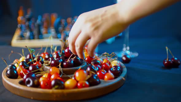 Close Up of Compartmental Dish with Different Varieties of Sweet Cherries on Table alt