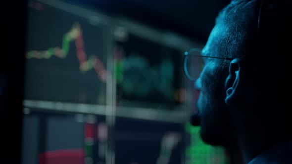Trader is Working with Multiple Computer Screens with Charts and Data Analysis and Stock Broker alt