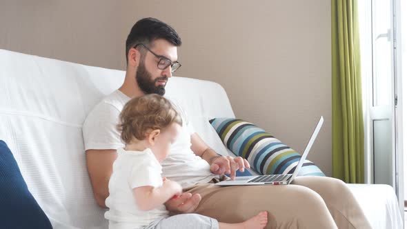 Bearded Clever Handsome Man in Glasses Working on the Laptop alt