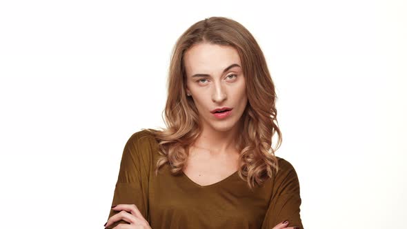 Bored Middleaged Caucasian Female with Long Brown Hair Looking at Camera Raising Eyebrow on White alt