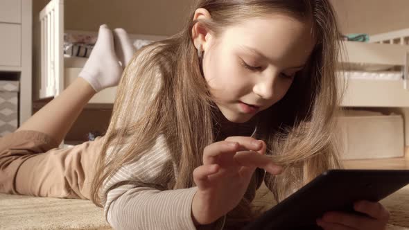 Brunette Girl at Home with a Tablet