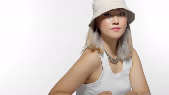 Blonde Korean Model Portrait in Studio with Hair Blowing Wearing a 90s Bucket Hat