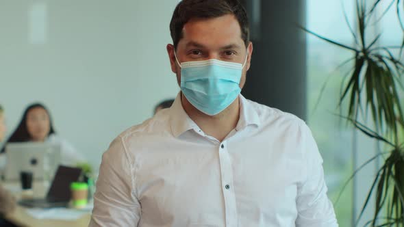 Portrait of Successful Young Businessman Wearing Protective Face Mask Looking Into Camera in alt